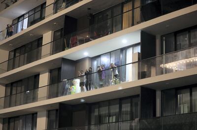 Residents cheer for doctors and medical staff from balconies in Mankhool, Bur Dubai, March 25, 2020. Pawan Singh / The National