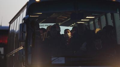 Migrants arrive on a bus at the port of Mytilini on the Greek island of Lesbos on Monday during the first day of the implementation of the deal between the EU and Turkey. Under the deal, migrants arriving illegally in Greece will be returned to Turkey if they do not apply for asylum or if they make an asylum claim that is rejected. Petros Giannakouris / AP