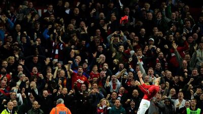Robin Van Persie celebrates scoring the equalising goal by throwing his shirt into the air during the English Premier League match against Chelsea at Old Trafford in Manchester. Peter Powell / EPA