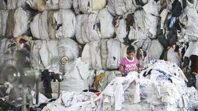 Workers process waste fabric at Hands Industries fabric recycling plant in Sharjah. Sarah Dea / The National