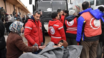 A Syrian civilian evacuated from the rebel-besieged Shiite villages of Foua and Kafraya is loaded into a bus on the eastern outskirts of Aleppo on December 22, 2016. The evacuation of the two villages is part of a deal to allow rebels and civilans to leave eastern Aleppo. George Ourfalian / AFP
