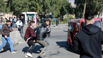 Iraqi protesters help their fellow who was affected by tear gas, which was dispensed by riot police during clashes following a protest at the Al-khilani square in central Baghdad, Iraq. EPA