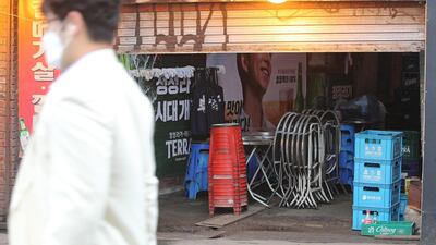 A man walks past a bar in Sinchon in western Seoul, South Korea. The Seoul city government issued an administrative order suspending business at clubs and bars after dozens of infections were reported. EPA