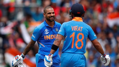India's Shikhar Dhawan celebrates his century against Australia with Virat Kohli. The opener has been ruled out for three weeks after scans revealed he had broken his thumb during the match at the Oval. Reuters