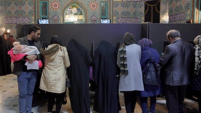 Iranian citizens fill out their ballot papers at a polling station during the parliamentary elections in Tehran. EPA