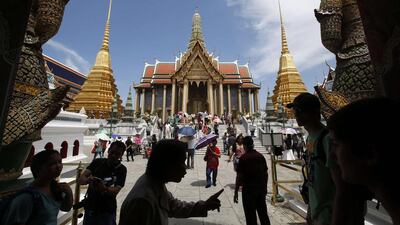 Tourists visit the Grand Palace in Bangkok. The Thai army's imposition of martial law is another blow to the country's tourist industry, adding to the economic pain from six months of destabilising street protests. REUTERS/Erik De Castro