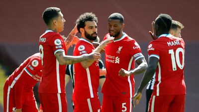 Liverpool's Mohamed Salah, centre, celebrates scoring the opening goal. PA