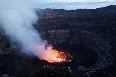 Smoke rises off of churning magma in the lava lake of Mount Nyiragongo, one of Africa's most active volcanos, outside Goma, Congo. AP