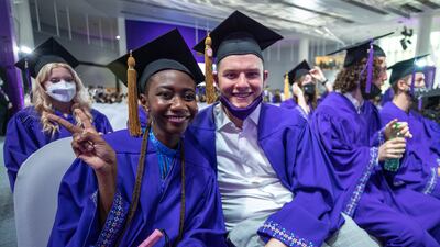 Price Maccarthy and Kacper Madejek Kim pose for the camera in their ceremonial gowns.