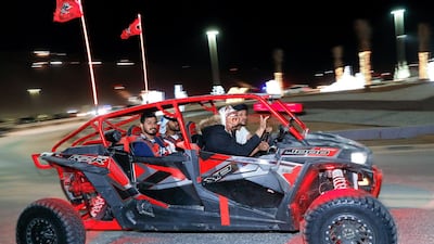 UTV enthusiasts cruising around the base of the Moreeb dunes. Victor Besa / The National