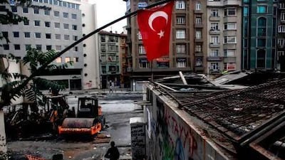 People walk near Gezi Park on Wednesday in Istanbul. Angelos Tzortzinis / AFP