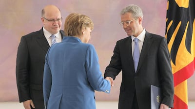 Angela Merkel shakes hands with Norbert Roettgen during a ceremony at Schloss Bellevue palace in May 2012 in Berlin. Getty Images