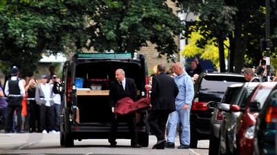 Her body is carried into a private ambulance from her house in Camden. EPA