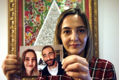 Aya Al Umari poses with a photo of herself and her brother Hussein on July 30, 2019. AP Photo