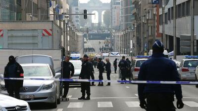 Policemen stand guard near a security perimeter set in the Rue de la Loi near the Maalbeek subway station, in Brussels, after an explosion killed around 10 people, according to spokesman of Brussels' fire brigade. Nicolas Maeterlinck / AFP / Belga