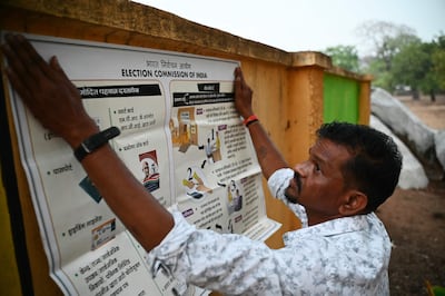 A voter awareness poster is displayed outside a polling station in Dugeli village, in Chhattisgarh state. AFP