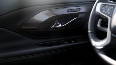 The Denali model's interior in minimal black with wooden veneer trim. Reem Mohammed / The National