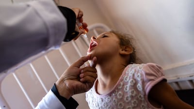 A nurse administers polio vaccine drops to a young Palestinian patient at the Nasser hospital in Khan Yunis in the southern Gaza Strip. AFP