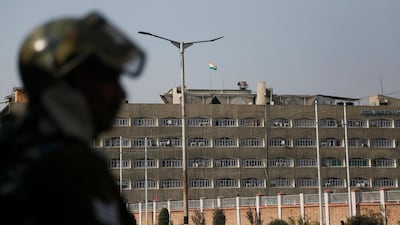 An paramilitary soldier stands guard as the Indian national flag flies atop the government secretariat in Srinagar, the main city in Kashmir, on October 31, 2019. AP Photo