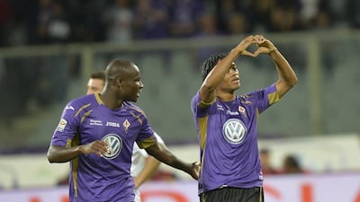 Fiorentina's Juan Cuadrado, right, celebrates after scoring the second of his side's three goals in a win over Inter Milan in Serie A on Sunday in Florence. Maurizio Degl'Innocenti / EPA / October 5, 2014