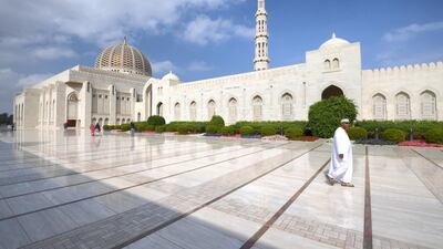 A worshipper walks in front of the Sultan Qaboos Grand Mosque in Muscat. AFP