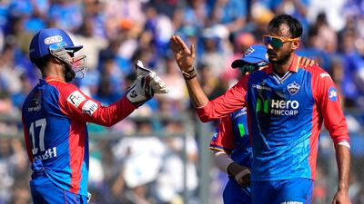 Delhi Capitals' Axar Patel, right, celebrates the dismissal of Mumbai Indians' Ishan Kishan for 42. AP