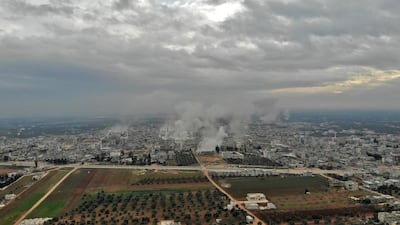 An aerial view of smoke plumes billowing from bombardment by the Syrian government forces and allies on the town of Sarmin, southeast of the city of Idlib. AFP.