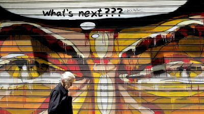 An elderly woman walks past graffiti beneath a freshly-written 'What's next???' message in central Athens, on 13 July 2015. Eurozone leaders have unanimously agreed to a new bailout programme for Greece. Orestis Panagiotou / EPA