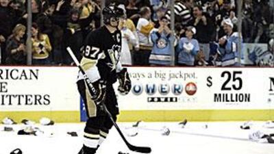 Sidney Crosby skates among spectators' hats after scoring his third goal against New York.
