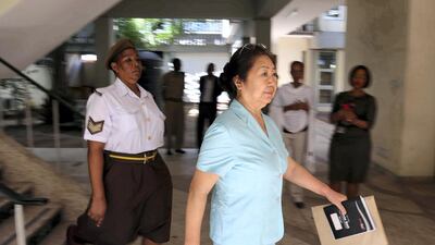 The 66-year-old, Yang Fenglan, escorted by Tanzania’s Prison warden as she was brought at Kisutu Resident’s Magistrate Court in Dar es Salaam, Friday November 04, 2016. AFP