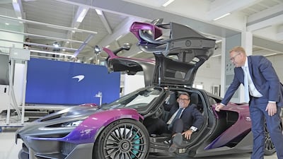 UK Prime Minister Andy Burnham sits inside a McLaren W1 during a visit to the car maker's site in Woking with McLaren Group chief executive Nick Collins. Reuters