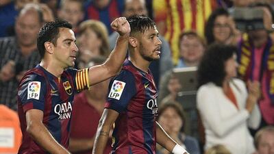 Barcelona's Xavi Hernandez, left, celebrates after scoring against Eibar in Barca's La Liga victory on Saturday. Lluis Gene / AFP / October 18, 2014