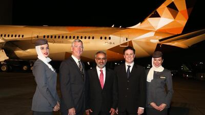 Larry Loftis, Boeing vice president and general manager - 787 Program, Abdulla Alsaboosi, Honourable Consul General to the UAE in Los Angeles, and Peter Baumgartner, Etihad Airways chief commercial officer, celebrate the roll out of Etihad Airways’ first Boeing 787-9 Dreamliner in Seattle. Courtesy Etihad