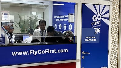 Go First staff work at the airline ticket counter at Indra Gandhi International Airport in New Delhi. AP