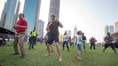 Participants work out at the closing weekend carnival of the second year of the Dubai Fitness Challenge at Burj Park, Dubai. Leslie Pableo for The National