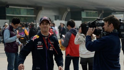 Red Bull driver Daniel Ricciardo of Australia smiles after finishing with the fourth fastest time during the second practice session of the Formula One Chinese Grand Prix in Shanghai on April 18, 2014. AFP PHOTO/Mark RALSTON