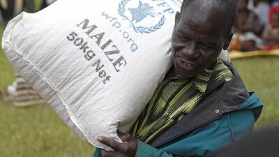 A Malawian man carries food aid distributed by the United Nations World Food Progamme in Mzumazi village near the capital Lilongwe, February 3, 2016. Mike Hutchings/ Reuters