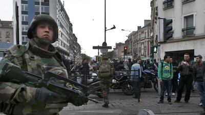 French soldiers secure the area as shots are exchanged in Saint-Denis, France, near Paris, during an operation to catch fugitives from Friday night’s deadly attacks in the French capital. Jacky Naegelen / Reuters