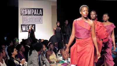 Models present creations made of bark cloth material by fashion designer Jose Hendo during the first fashion week show held in Kampala. Amy Fallon / AFP Photo