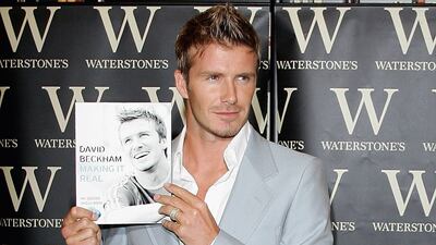 David Beckham, in a pale blue blazer and half-tucked shirt, signs copies of his new book at Waterstones on September 18, 2006 in London, England. Getty Images