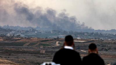 Israeli ultra-Orthodox Jews watch from Sderot as Israeli forces bombard the northern Gaza Strip. AFP