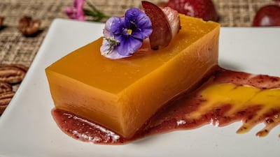 Mango and orange jellies garnished with edible flowers, strawberries and grapes. AFP
