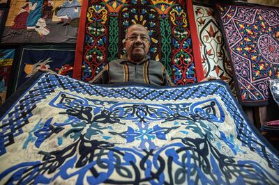An Egyptian craftsman showcases a tapestry in his shop in Khayamiya Street, or the Street of Tent-makers, in the old city of the Egyptian capital Cairo. AFP