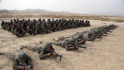 A group of Afghan National Army soldiers watch others participate in a live fire exercise at the Afghan Military Academy, in Kabul. AP