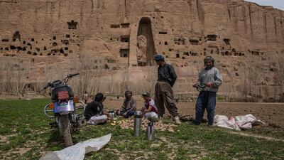 Potato farmers take a break from planting their crop near the remains of Bamyan's giant Buddha statues that were blown up by the Taliban in 2001.