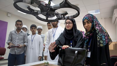 ABU DHABI, UNITED ARAB EMIRATES, Dec. 30, 2014:
(2R) Fatima al Harmoudi, 15, and Reem Abdullah, 17, navigate a drone while they work with other students from Abu Dhabi high schools during Tech Quest, a Higher Colleges of Technology program, on Tuesday, Dec. 30, 2015, at the Higher Colleges of Technology Men's College in Abu Dhabi. The program, which celebrates its 15th edition, attracts Emirati students for hands-on workshops and talks with industry speakers that aim to motivate the students to pursue science, technology, engineering and math (STEM) education.(Silvia Razgova / The National) / Usage: Dec. 30 / Section: AL / Reporter: Roberta Pennington *** Local Caption *** SR-141230-techquest04.jpg