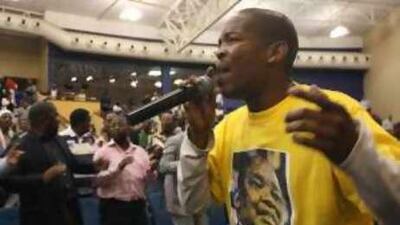 At Rosebank Union Church, a singer in a Mosiuoa 'Terror' Lekota T-shirt warms up the crowd ahead of an address by the ANC dissident and former party chairman.