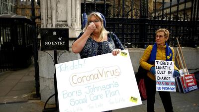 A protester stands outside the UK Houses of Parliament following the outbreak of coronavirus, in London on March 11, 2020. Reuters