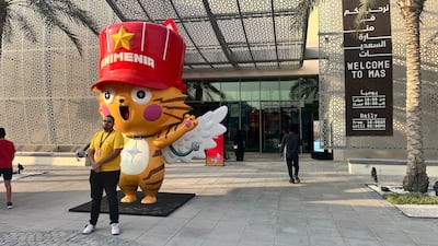 A large cute cat greets fans upon entry to Animenia Abu Dhabi. Photo: Faisal Salah / The National