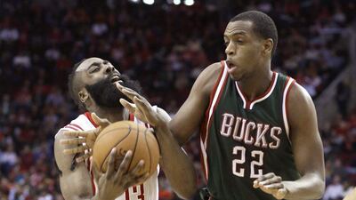 Khris Middleton, right, of the Milwaukee Bucks guards James Harden of the Houston Rockets during their NBA contest on Friday. Pat Sullivan / AP / February 6, 2015